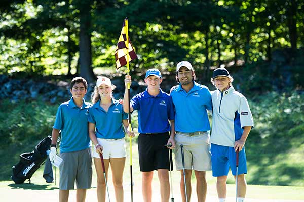 boys and girl holding golf flag and clubs