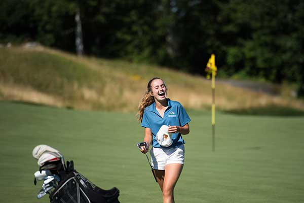 girl laughing on golf course